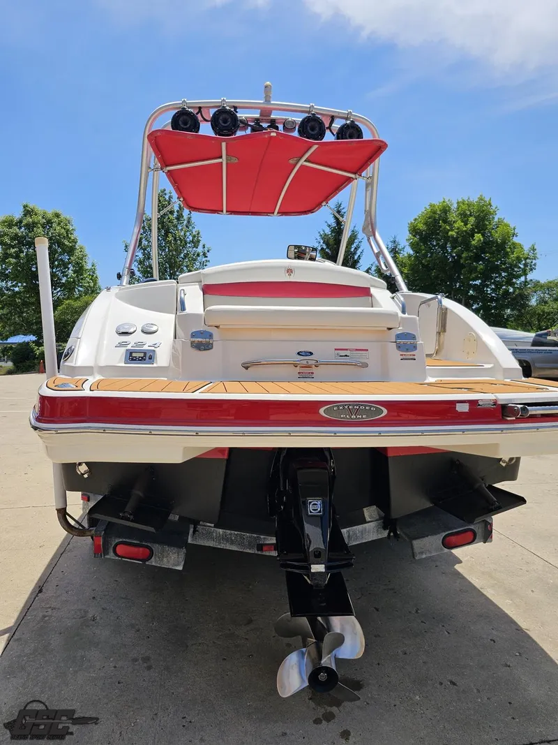 Slide: The Image of 2008 Chaparral Sunesta 224 boat, rear view with red canopy and outboard motor. - 28