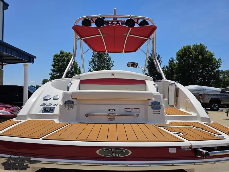 Slide: The Image of 2008 Chaparral Sunesta 224 boat with red canopy and teak deck, rear view. - 29