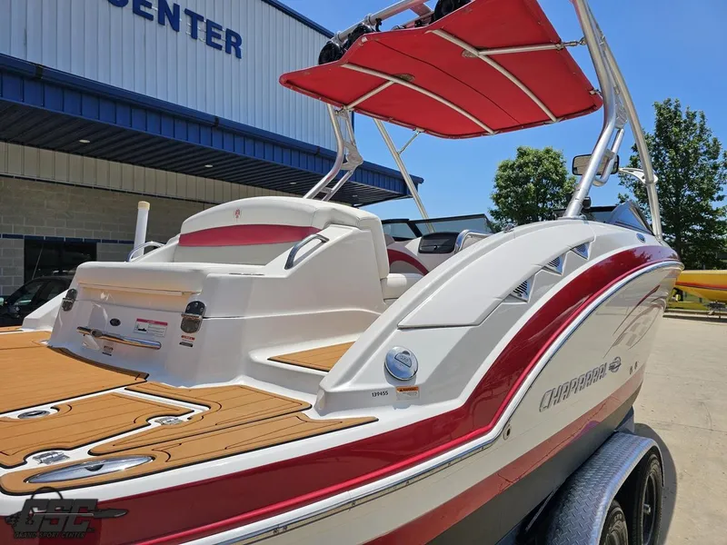 Slide: The Image of 2008 Chaparral Sunesta 224 boat with red accents, parked at a sports center. - 30