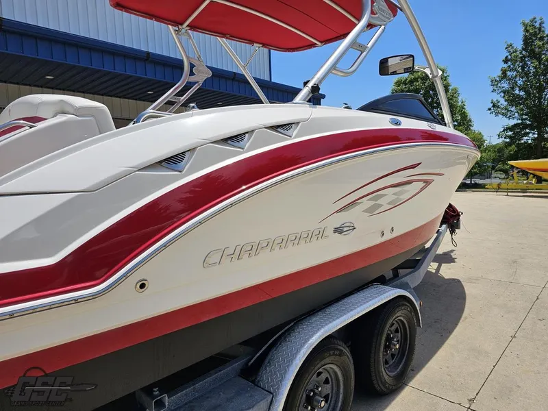 Slide: The Image of 2008 Chaparral Sunesta 224 boat with red accents on a trailer, outdoor setting. - 31