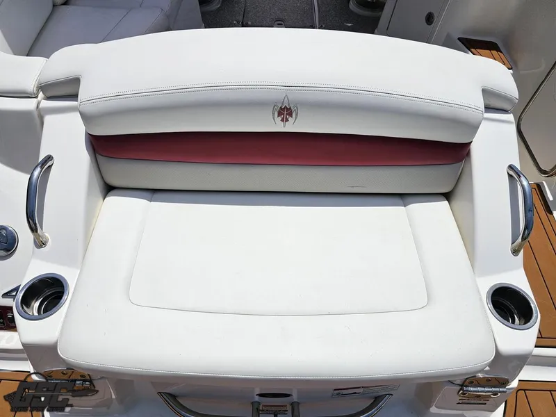 Slide: The Image of 2008 Chaparral Sunesta 224 boat seat with white and red upholstery, featuring cup holders. - 35