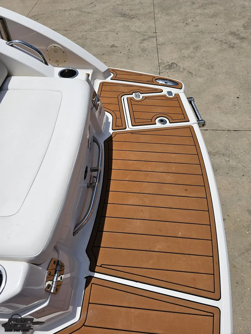 Slide: The Image of 2008 Chaparral Sunesta 224 boat deck with teak-style flooring and white seating. - 37