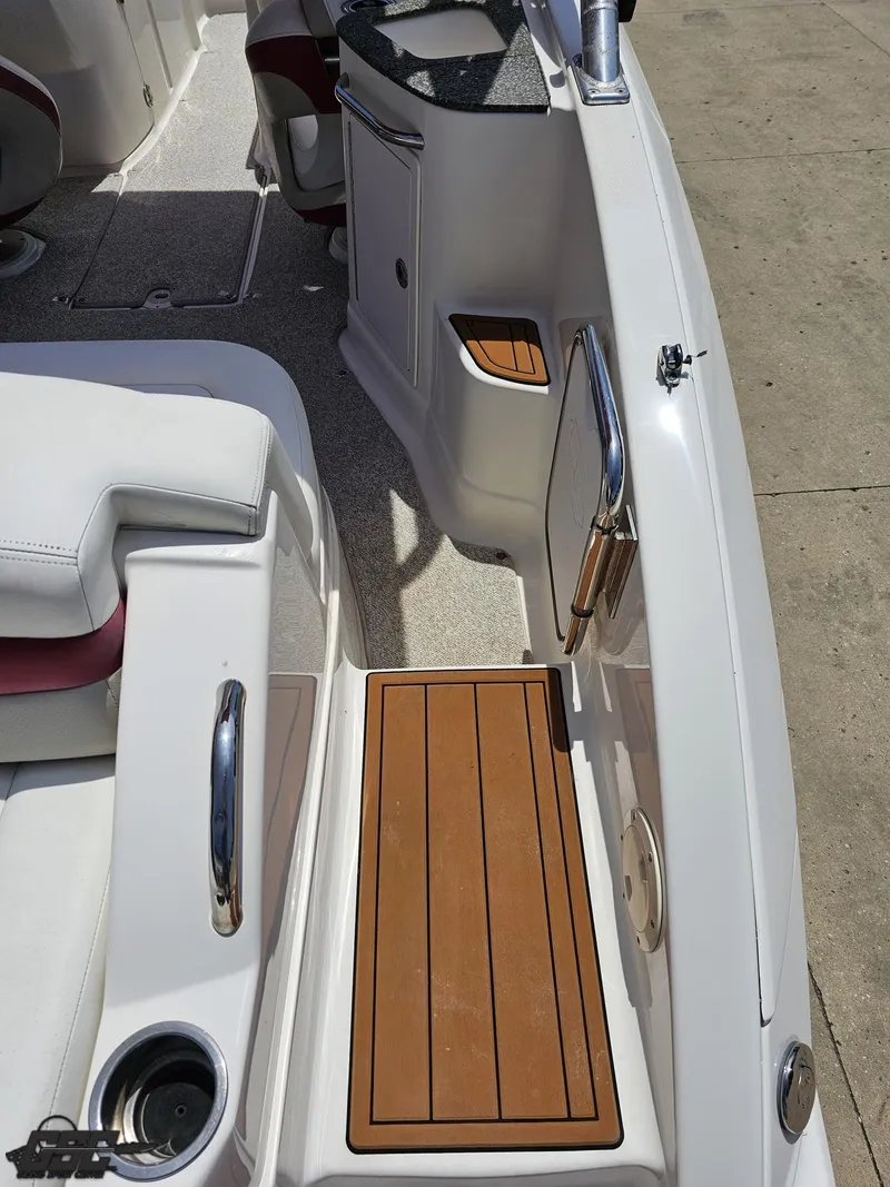 Slide: The Image of 2008 Chaparral Sunesta 224 boat interior with white seating and wood accents. - 39