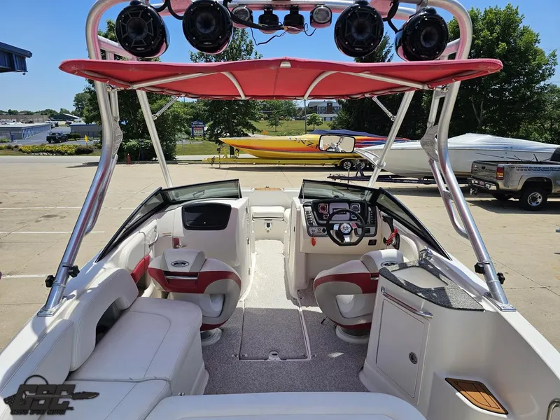 Slide: The Image of 2008 Chaparral Sunesta 224 boat interior with red canopy and modern dashboard. - 42