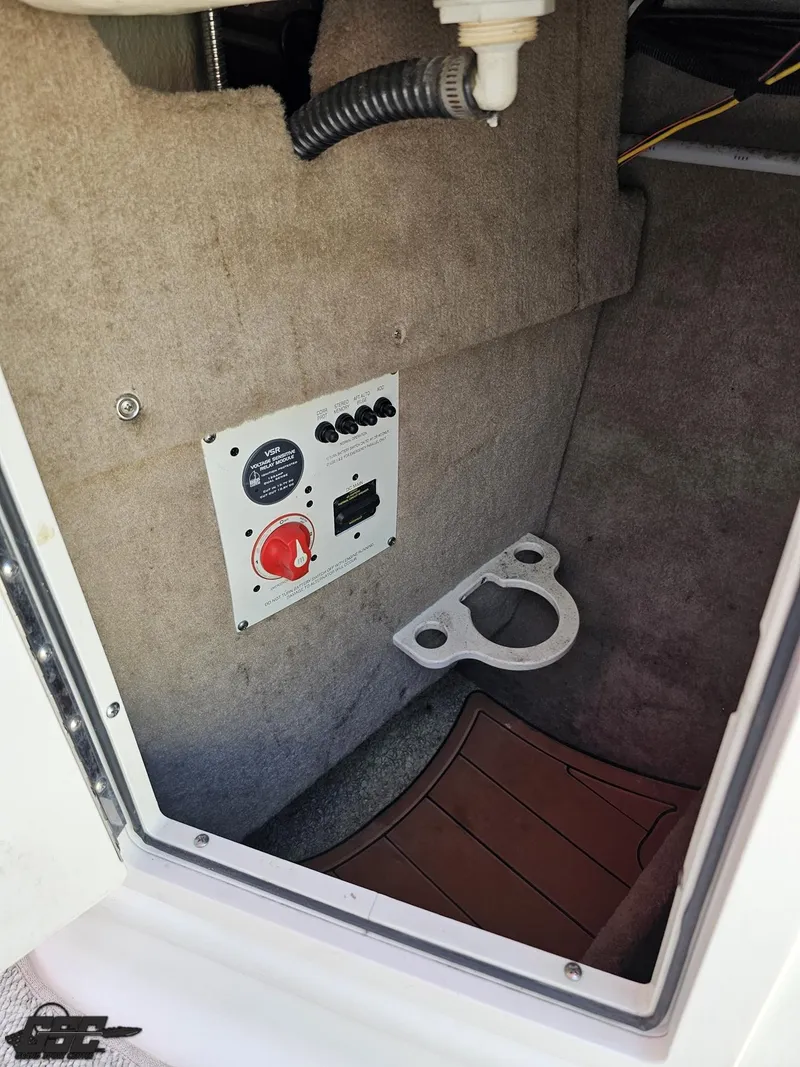 Slide: The Image of 2008 Chaparral Sunesta 224 boat interior with control panel and storage compartment. - 47