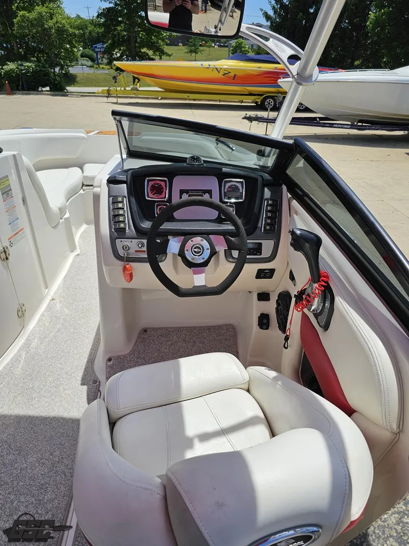 Slide: The Image of 2008 Chaparral Sunesta 224 boat cockpit with steering wheel and dashboard controls. - 48