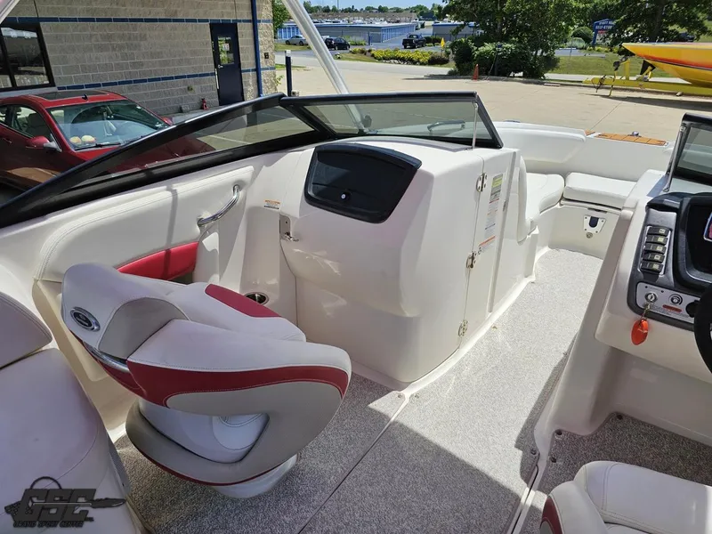 Slide: The Image of 2008 Chaparral Sunesta 224 boat interior with red and white seating, dashboard, and steering wheel. - 49