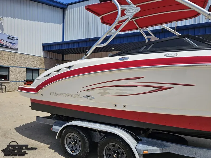 Slide: The Image of 2008 Chaparral Sunesta 224 boat with red accents on a trailer outside a building. - 5