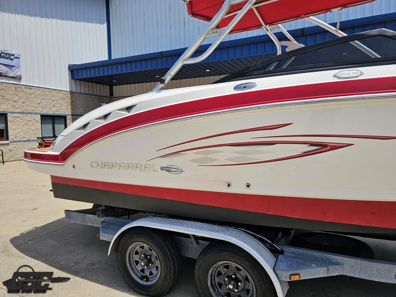 Slide: The Image of 2008 Chaparral Sunesta 224 boat on trailer, featuring red and white design. - 6