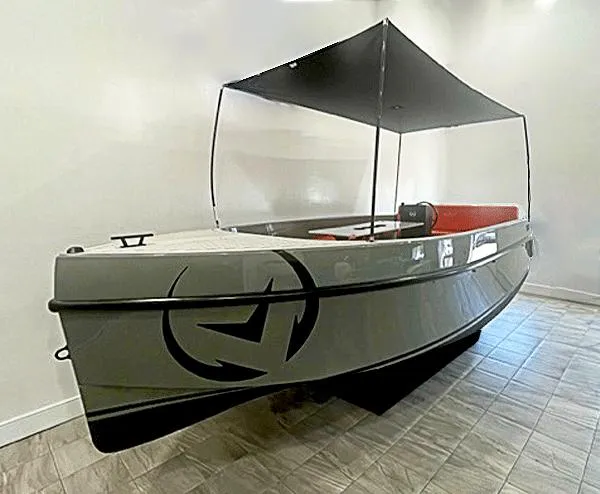 The Image of 2024 Vision Marine Technologies Volt 180 boat with canopy, displayed indoors. - 0
