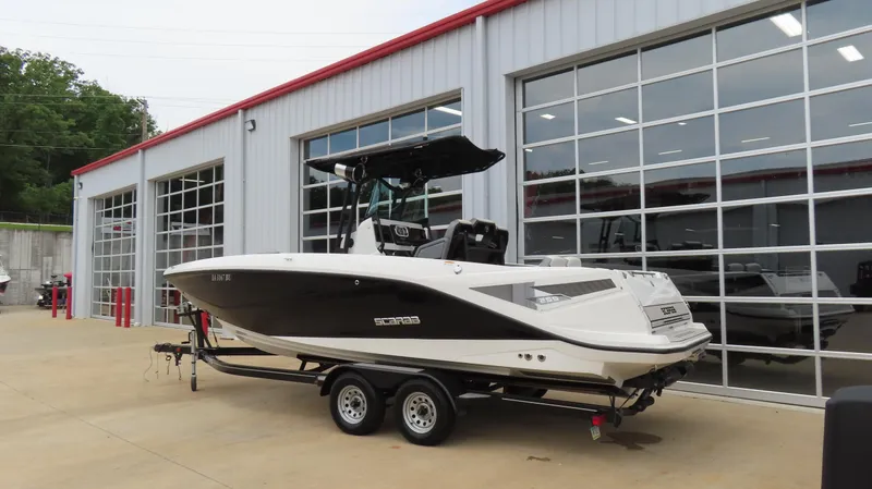 The Image of 2020 Scarab 255 Open G boat on trailer outside a modern garage. - 1