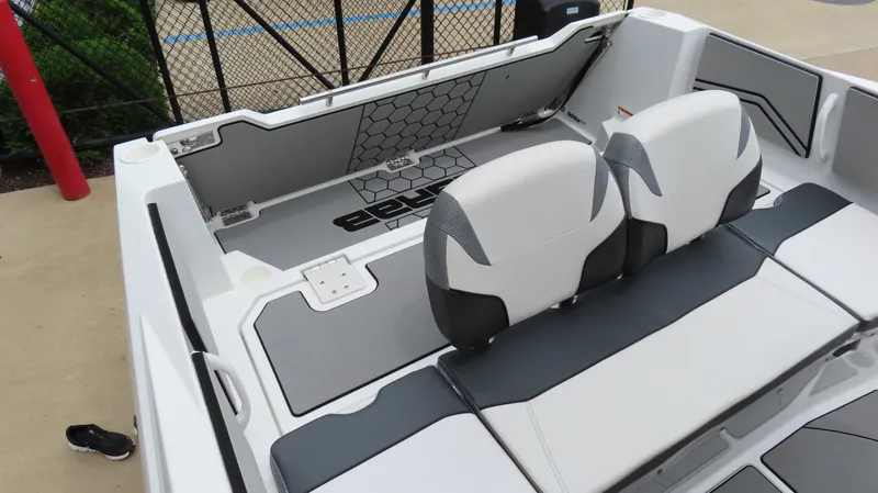 Slide: The Image of 2020 Scarab 255 Open G boat interior with white and gray seating and hexagonal design. - 13