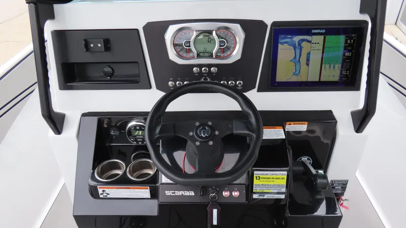 Slide: The Image of 2020 Scarab 255 Open G dashboard with steering wheel, gauges, and navigation display. - 16