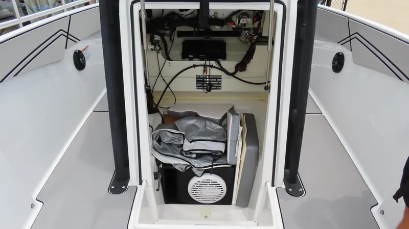 Slide: The Image of 2020 Scarab 255 Open G boat interior showing storage and electrical components. - 22