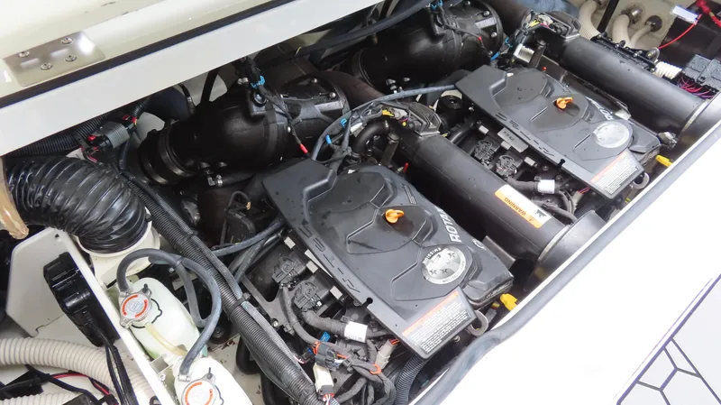Slide: The Image of Engine compartment of a 2020 Scarab 255 Open G boat, featuring dual Rotax engines. - 24