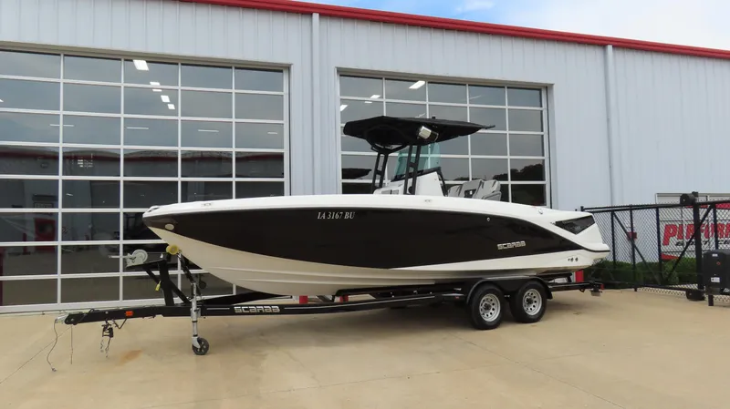 Slide: The Image of 2020 Scarab 255 Open G boat on trailer, parked outside a building. - 4