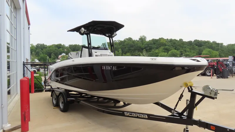 Slide: The Image of 2020 Scarab 255 Open G boat on trailer, parked outdoors near a building. - 6