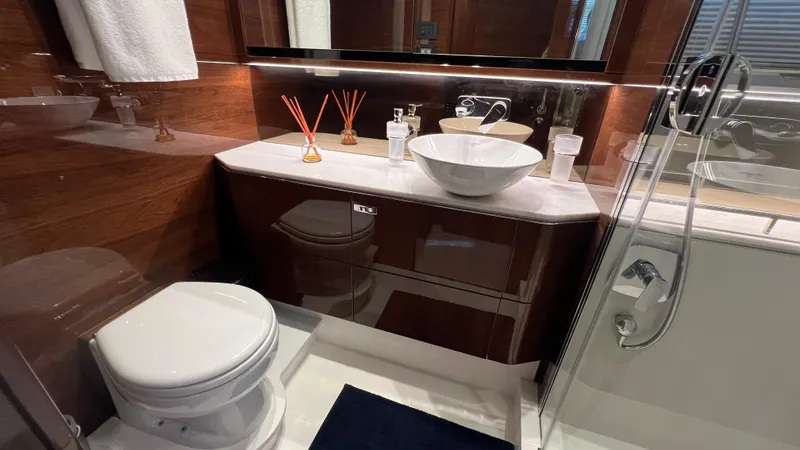 Slide: The Image of Luxurious bathroom in 2019 Princess F62 yacht with modern fixtures and elegant wood finish. - 24