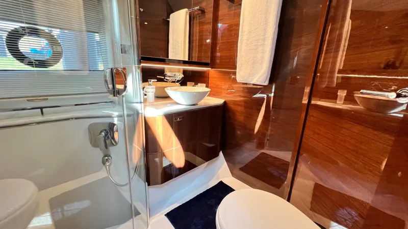 Slide: The Image of Luxurious bathroom in 2019 Princess F62 yacht with modern fixtures and elegant wood paneling. - 28