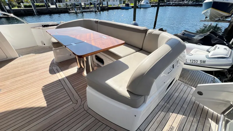 Slide: The Image of Luxurious seating area on 2019 Princess F62 yacht with wooden table, docked by the water. - 34