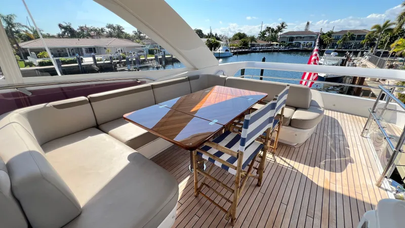 Slide: The Image of Luxurious 2019 Princess F62 yacht deck with seating, table, and waterfront view. - 38