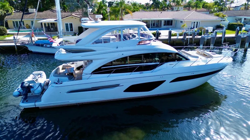 Slide: The Image of Luxurious 2019 Princess F62 yacht docked in a serene waterfront setting. - 4