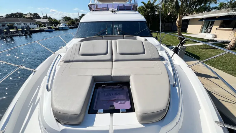 Slide: The Image of Luxurious 2019 Princess F62 yacht with sunbathing deck, docked in a scenic marina. - 47