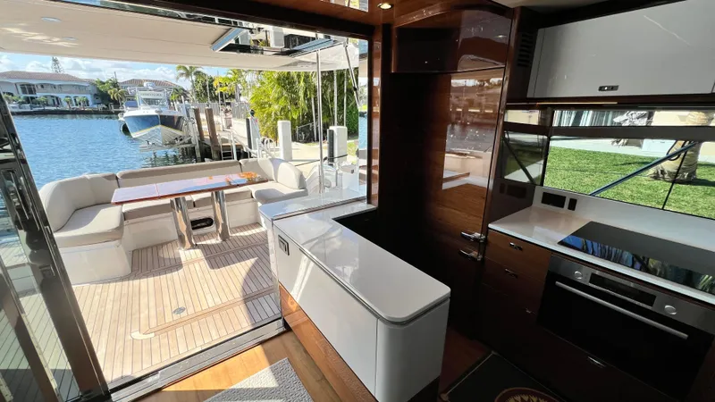 Slide: The Image of Luxurious 2019 Princess F62 yacht interior with modern kitchen and outdoor seating area. - 8