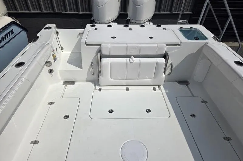 Slide: The Image of 2026 Parker 2421 EXPLORER boat deck with seating and storage compartments. - 10