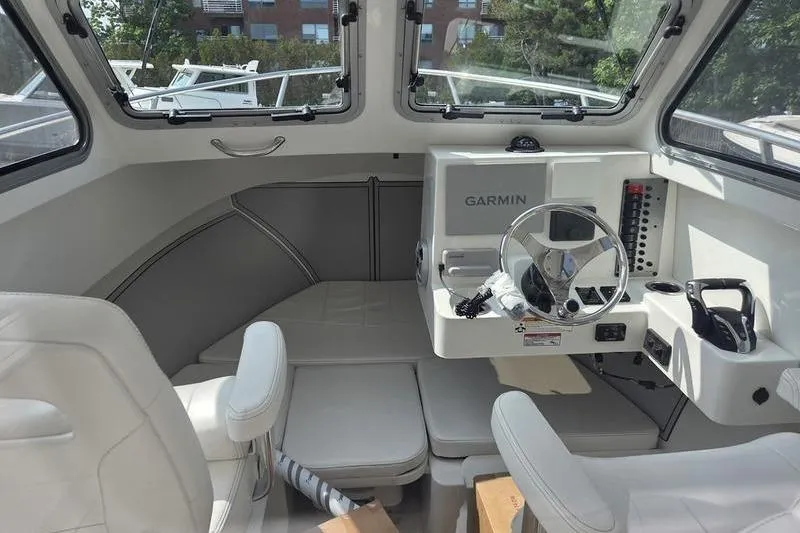 Slide: The Image of Interior of 2026 Parker 2421 Explorer boat with Garmin navigation system and seating. - 11