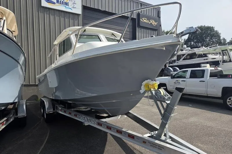 Slide: The Image of 2026 Parker 2421 EXPLORER boat on trailer, parked outside marine dealership. - 9