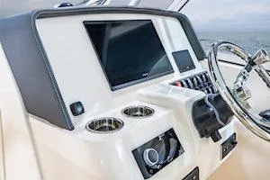 Slide: The Image of 2026 Grady-White Freedom 285 boat dashboard with modern controls and steering wheel. - 10