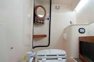 Slide: The Image of 2026 Grady-White Freedom 285 boat interior, featuring a compact bathroom with modern amenities. - 11