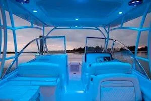 Slide: The Image of 2026 Grady-White Freedom 285 boat interior with blue ambient lighting at dusk. - 12