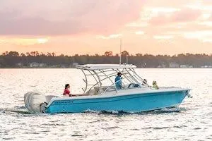 Slide: The Image of 2026 Grady-White Freedom 285 boat cruising on water at sunset. - 3