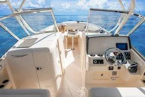 Slide: The Image of 2026 Grady-White Freedom 285 boat interior with ocean view, featuring modern controls and seating. - 4
