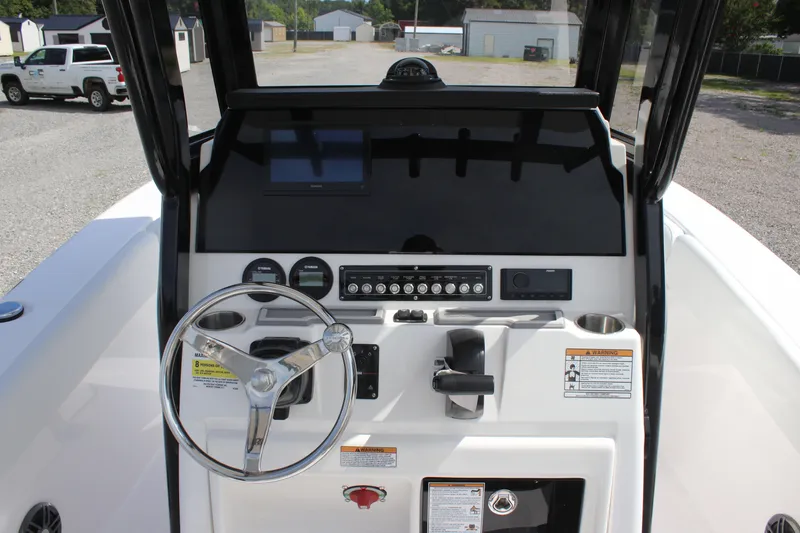 Slide: The Image of 2026 Sea Fox 228 Commander boat dashboard with steering wheel and control panel. - 23