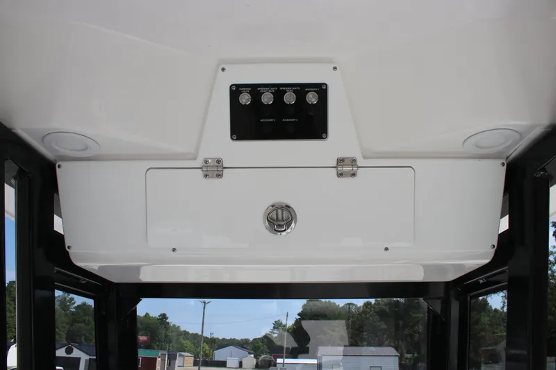 Slide: The Image of 2026 Sea Fox 228 Commander boat console with control panel and storage compartment. - 24