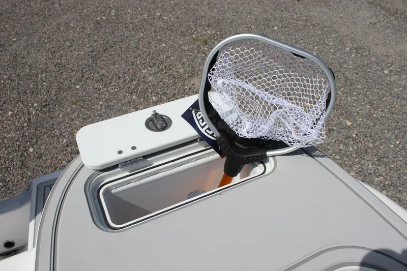 Slide: The Image of Fishing net on Sea Fox 228 Commander boat, 2026 model, with open storage compartment. - 27