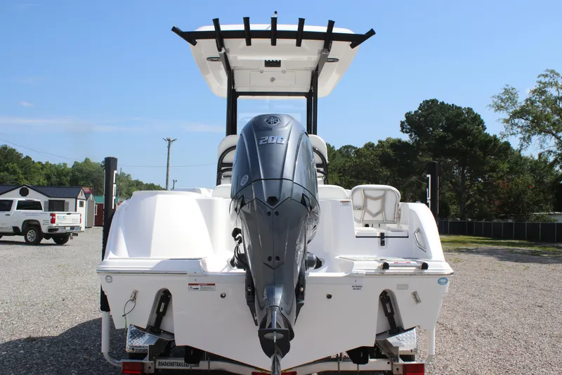 Slide: The Image of 2026 Sea Fox 228 Commander boat with powerful outboard motor, parked outdoors. - 7