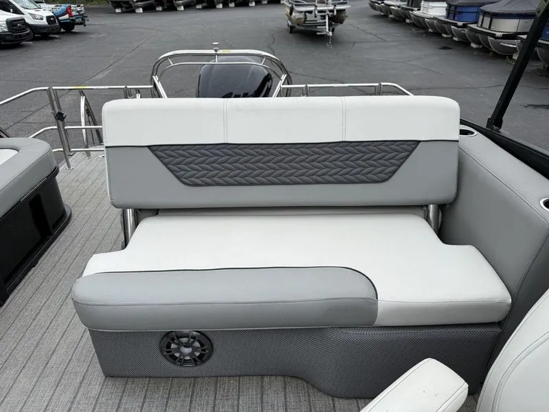 Slide: The Image of 2021 Godfrey Monaco 235 SFL GTP boat interior with gray seating and speaker. - 16