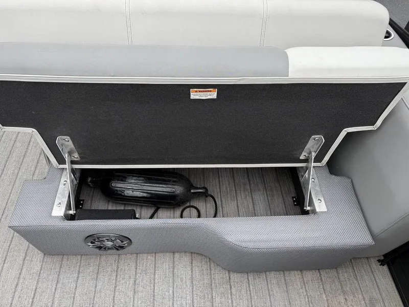 Slide: The Image of Storage compartment in a 2021 Godfrey Monaco 235 SFL GTP boat, featuring a speaker and equipment. - 19