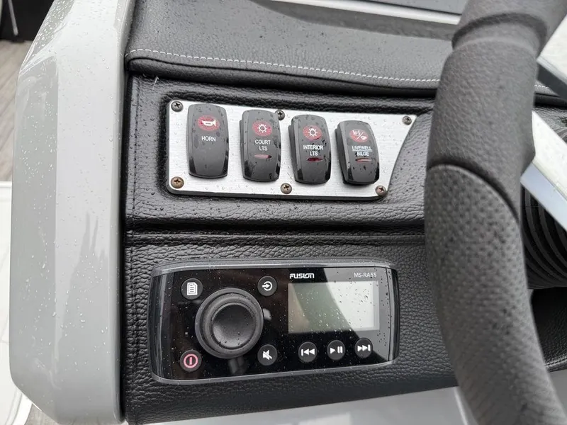 Slide: The Image of Control panel of 2021 Godfrey Monaco 235 SFL GTP boat with switches and audio system. - 24