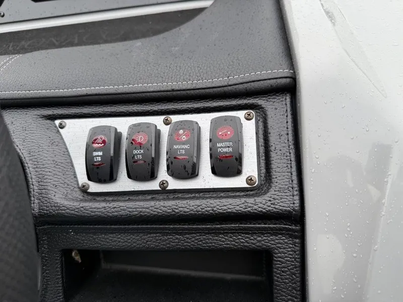 Slide: The Image of Control panel of a 2021 Godfrey Monaco 235 SFL GTP boat with switches for lights and power. - 25