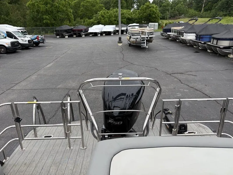 Slide: The Image of 2021 Godfrey Monaco 235 SFL GTP boat in a parking lot with other boats. - 27