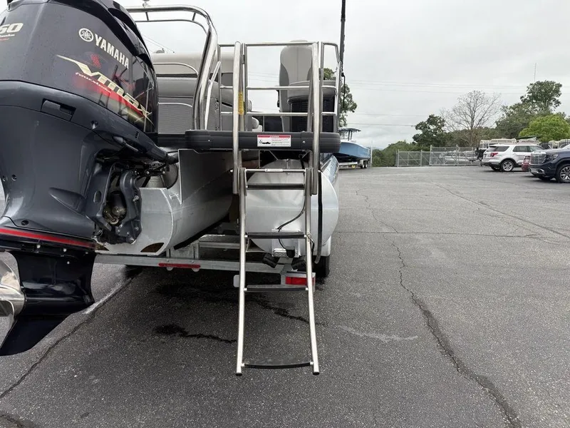Slide: The Image of 2021 Godfrey Monaco 235 SFL GTP boat with Yamaha engine and ladder in parking lot. - 29