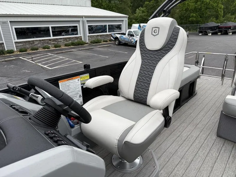 Slide: The Image of Captain's chair on 2021 Godfrey Monaco 235 SFL GTP boat, featuring sleek design and modern controls. - 6