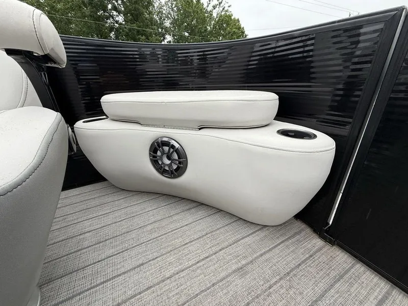 Slide: The Image of 2021 Godfrey Monaco 235 SFL GTP boat interior with white seating and speaker. - 8