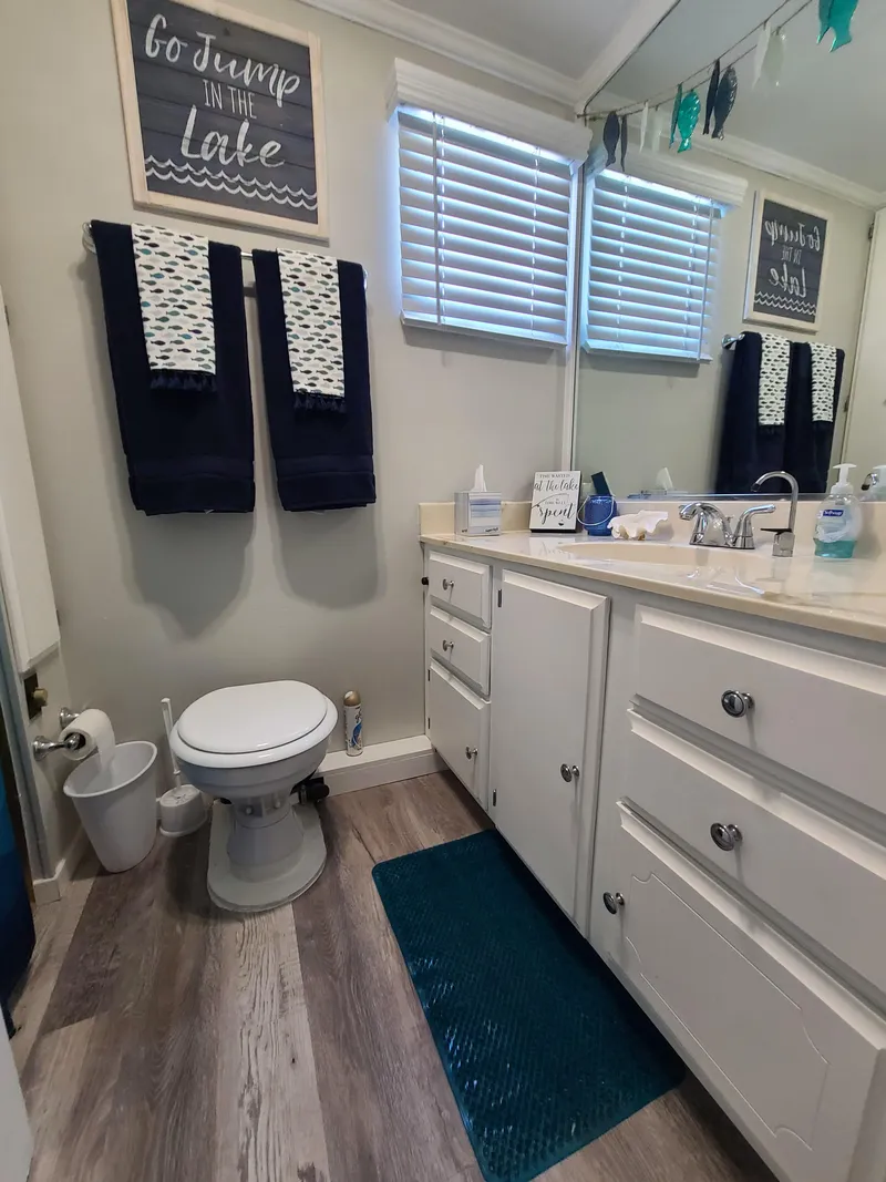 Slide: The Image of 1977 Stardust Cruisers houseboat interior with dining area, modern decor, and natural lighting. - 16