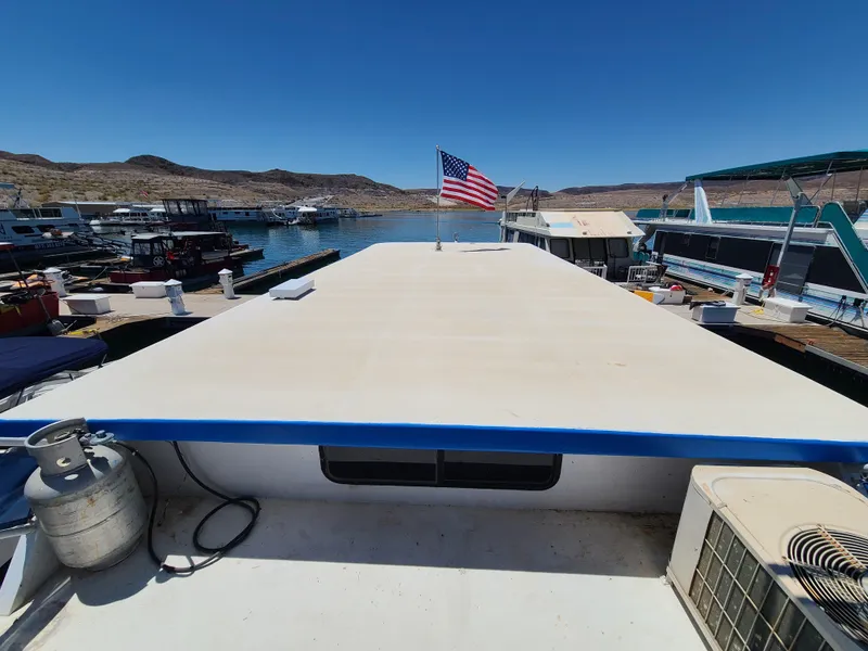 Slide: The Image of 1977 Stardust Cruisers houseboat bathroom with nautical decor, white cabinets, and blue accents. - 18